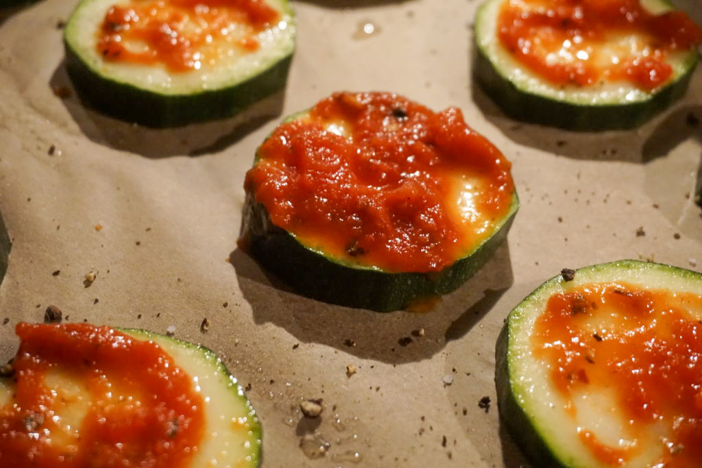 adding the marinara sauce to the pizza bites