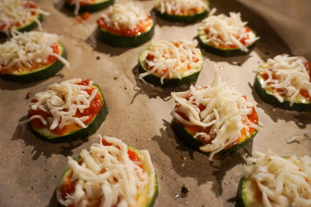 shredded mozzarella cheese added to zucchini pizza bites 