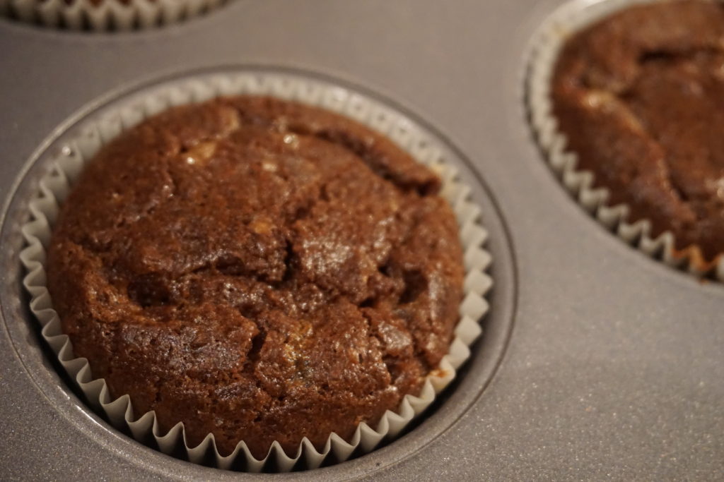 Baked keto chocolate cupcake inside a muffin pan