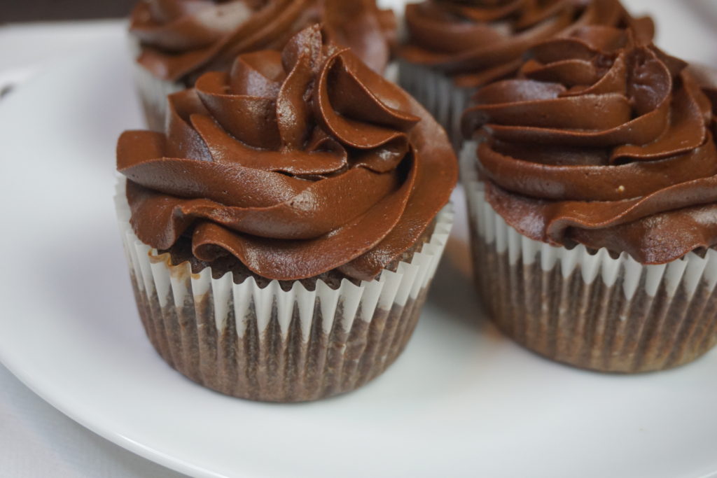 Espresso buttercream onto of four keto chocolate cupcakes 