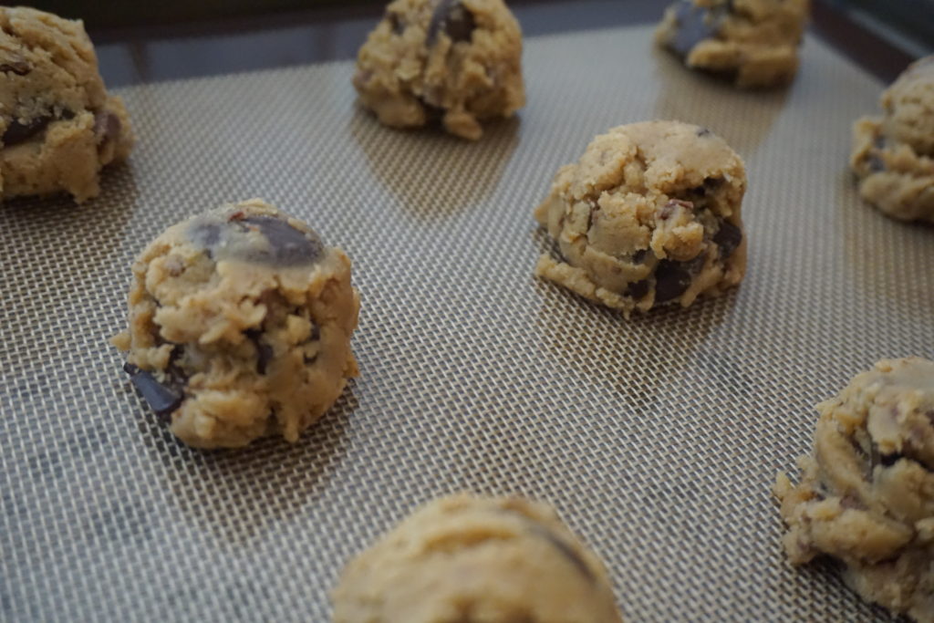 Brown butter chocolate chip cookie dough on a silicon tray before baking