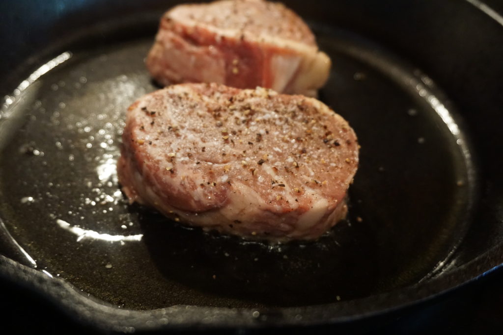 Raw filet entering an oiled cast iron skillet. 