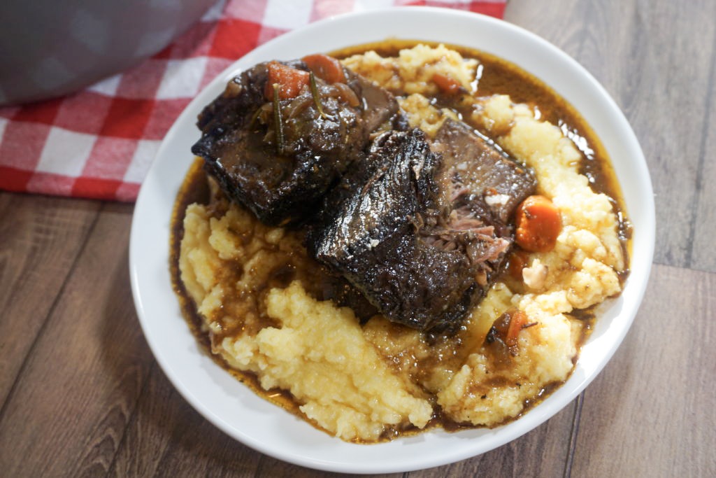 Plated short ribs with the sauce and polenta