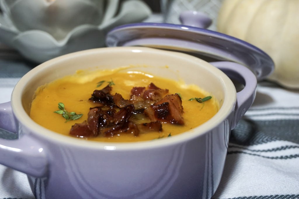 Garnished butternut squash soup with crispy bacon