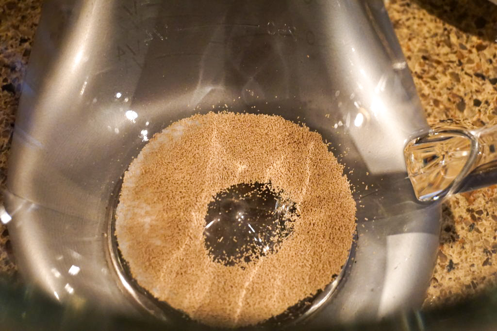 In the bowl of an electric mixer: yeast and granulated sugar 
