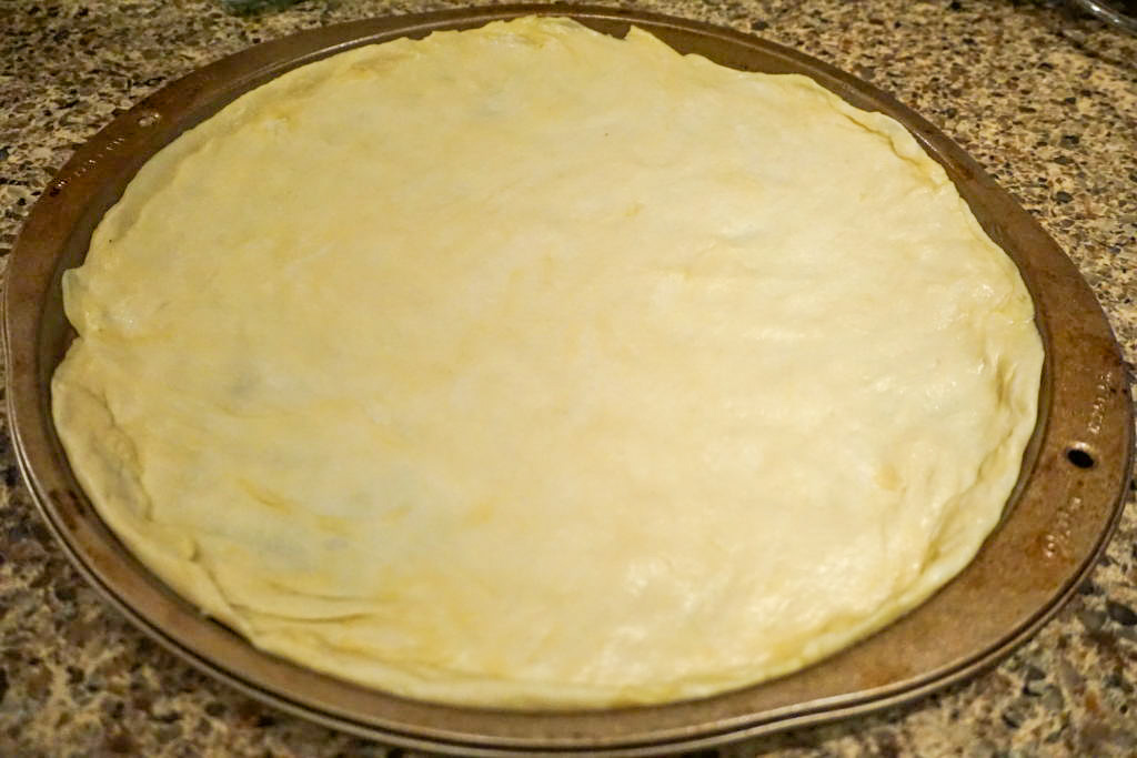 Pizza dough spread out 