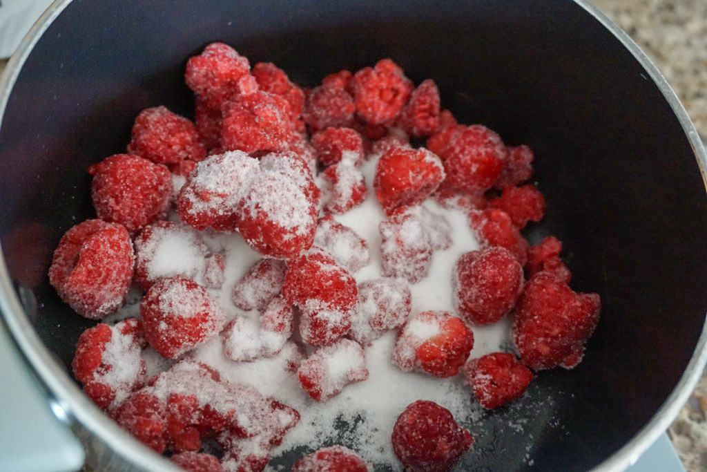 Cooking the frozen raspberries and sugar for the ganache