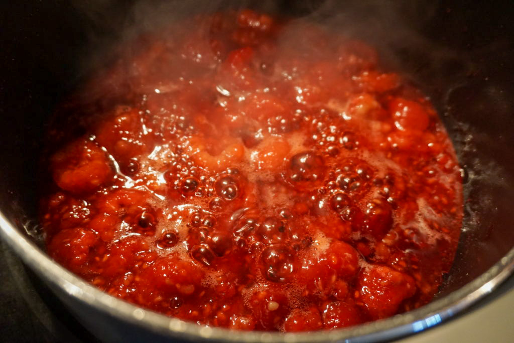 Boiling the frozen raspberries and sugar