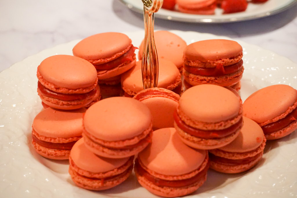 A display of raspberry macarons with a raspberry filling