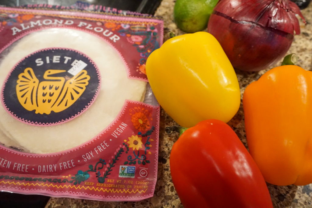 Some of the ingredients: bell peppers, almond tortillas, red onion, and a lime