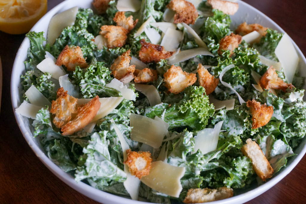 A kale caesar salad with homemade croutons