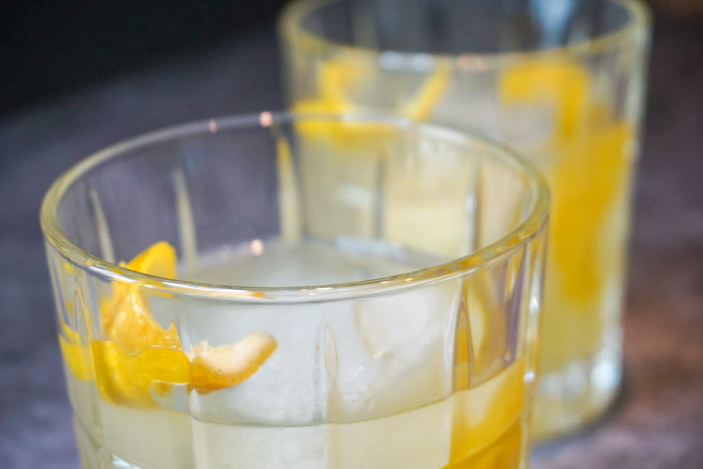 Inside the cocktail with fresh lemon twist slice