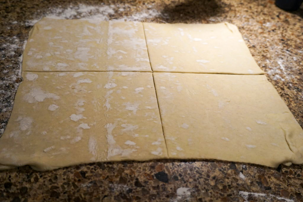 cutting the puff pastry into 4 squares 