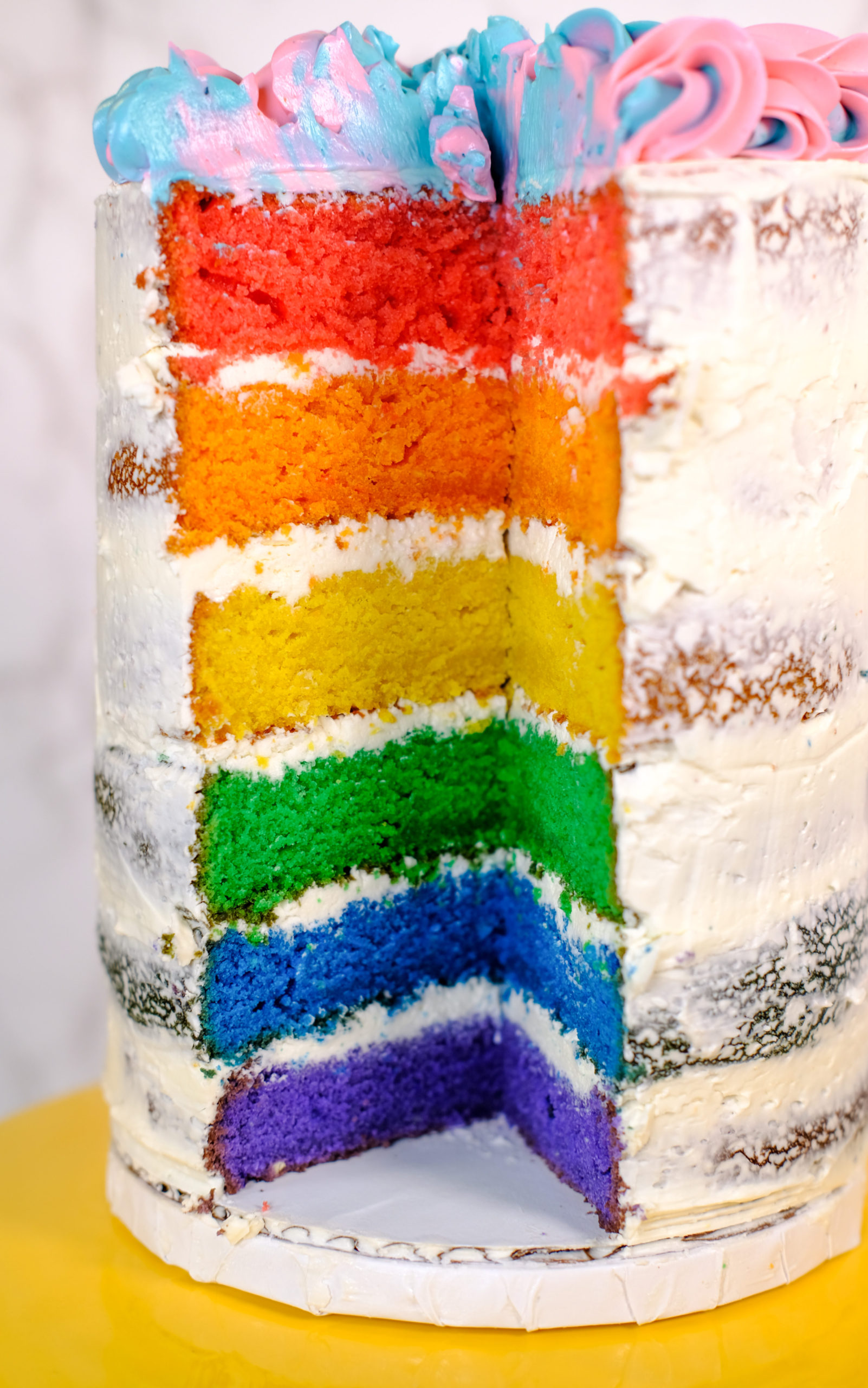 close-up of the cut into rainbow cake