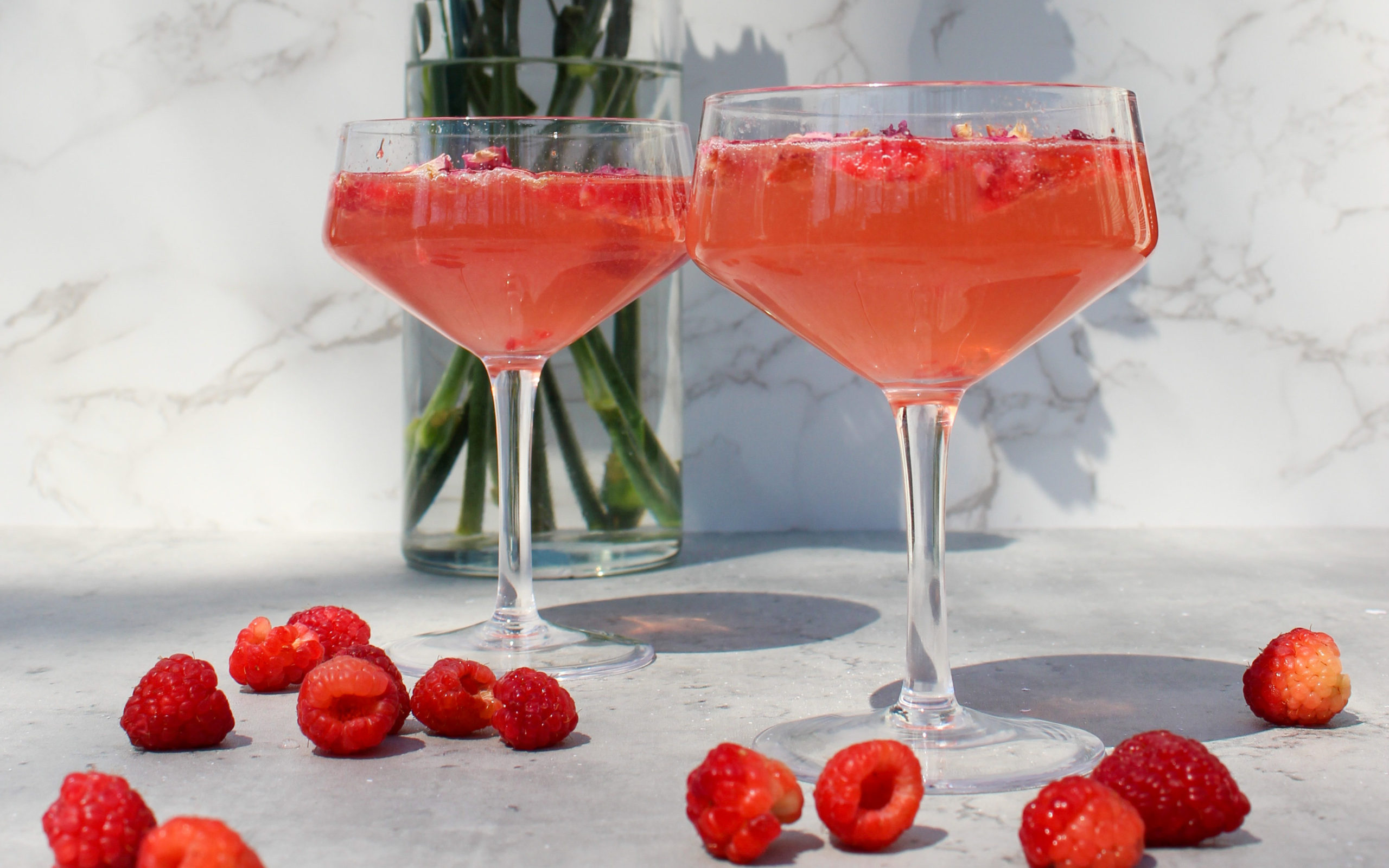 overview of the cocktail with fresh raspberries and flowers 