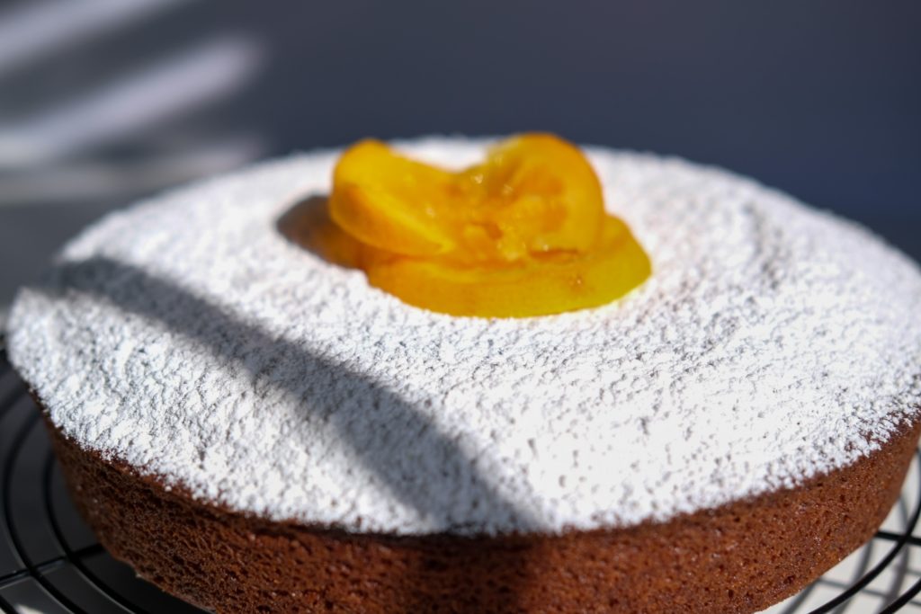 the full cake with powdered sugar and candied oranges 
