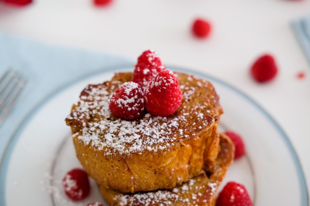 close-up of the French toast with raspberries and powdered sugar
