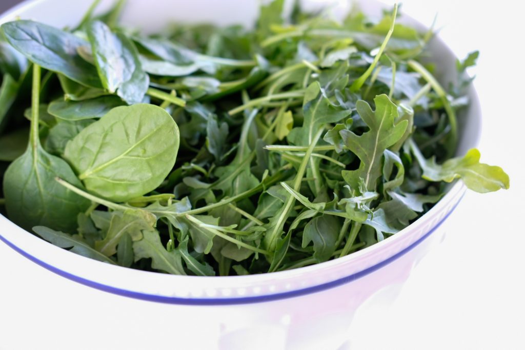 baby arugula and baby spinach in a bowl