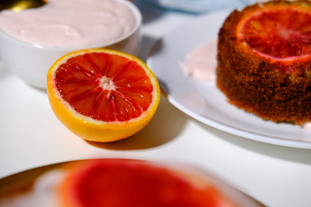 an sliced orange with the tea cake in the background