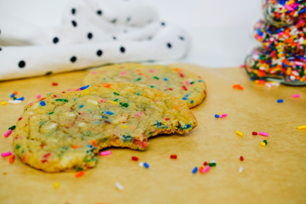 a bitten cookie with sprinkles