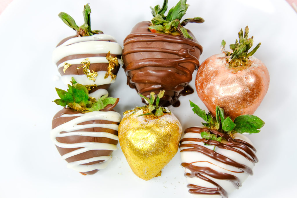 up top view of large chocolate covered strawberries with gold and rose gold